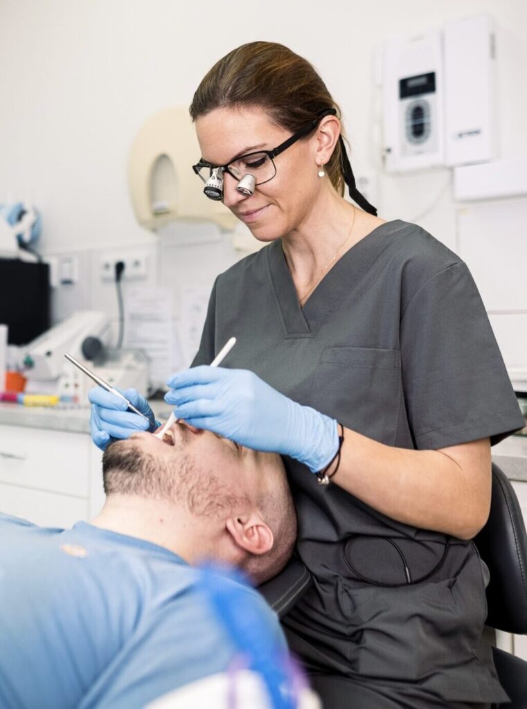 dentální hygienistka čistí zubní kámen